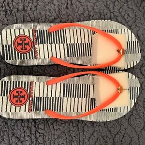 Women’s size 11 Tory Burch flip flops. Orange strap and logo, navy body